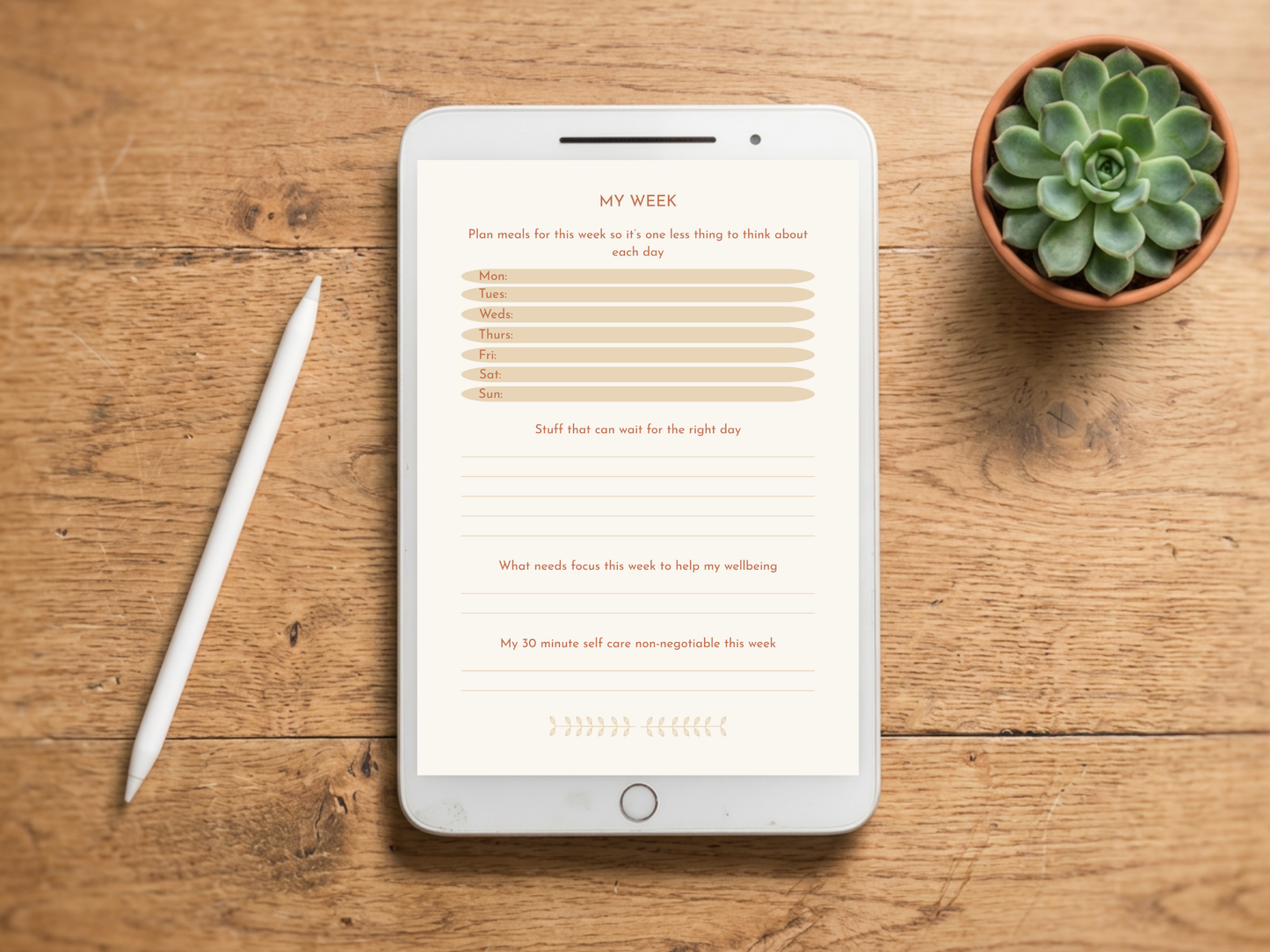 A tablet on a wooden tabletop displaying a weekly planner template, with a white stylus beside it and a small potted succulent in the upper right corner.